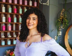 Client smiling with her natural curls after a cut