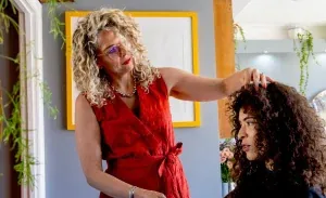 Anna cutting a client's curls at the Wivenhoe salon